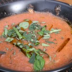 Delicious bowl of gazpacho with herbs.